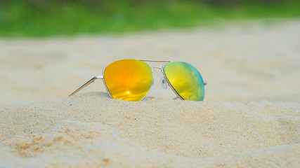 Fototapeta na wymiar Aviator style sunglasses on the beach