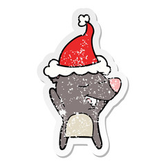 distressed sticker cartoon of a bear wearing santa hat