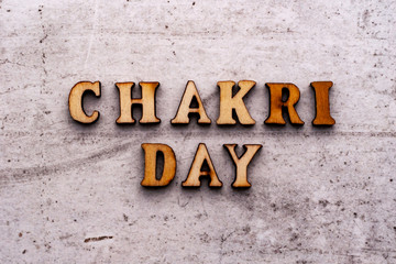 Inscription CHAKRI DAY in wooden letters on a light background