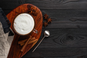 Obraz na płótnie Canvas coffee with milk on dark wooden background top view