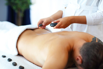 Handsome man having massage in spa salon