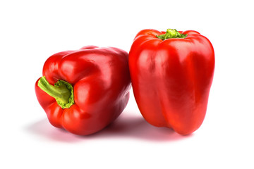 Two red bell peppers isolated on white background.