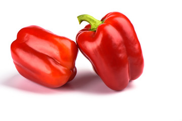 Two red bell peppers isolated on white background.