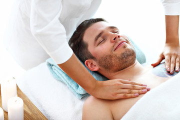 Obraz na płótnie Canvas Handsome man having massage in spa salon