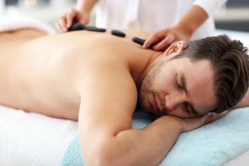 Fototapeta na wymiar Handsome man having massage in spa salon