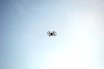 Drone in flight against the sky, new technologies in aerial photography.