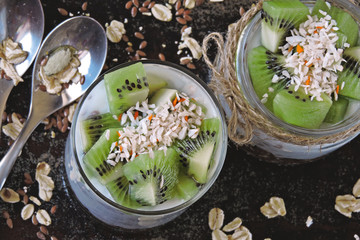 Healthy breakfast or snack with granola, seeds, yogurt and kiwi. Keto diet. Vegetarian dessert.