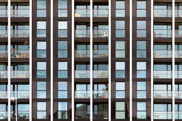 Glass blue square Windows of facade modern city business building skyscraper. Modern apartment buildings in new neighborhood. Windows of a building, texture.