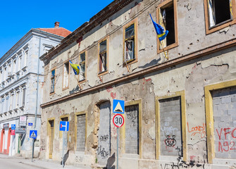Building in Mostar damaged by the war and still not renovated. Ruined by bullet holes, mortar bomb shell grenade damage