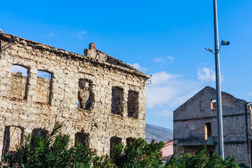 Fototapeta na wymiar Abandoned building, detroyed during Bosnian War at Bulevar Street in Mostar city, Bosnia and Herzegovina
