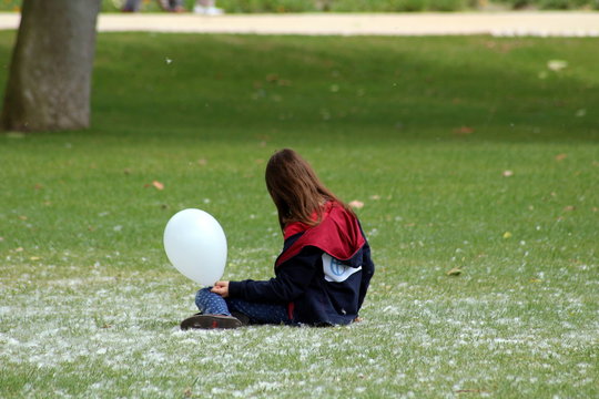 girl playing with balloon in the park