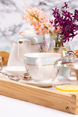 Morning tea concept. Flowers, tea and strudel on a tray