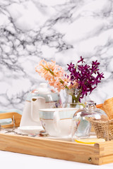 Morning tea concept. Flowers, tea and strudel on a tray