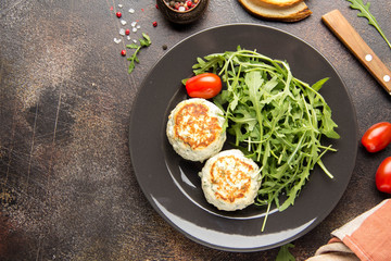 Fried chicken cutlet with herbs, delicious healthy lunch, children's food, diet. Meatballs with salad on dark background