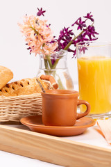 Morning coffee concept. Flowers, coffe and strudel on a tray