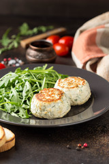 Fried chicken cutlet with herbs, delicious healthy lunch, children's food, diet. Meatballs with salad on dark background