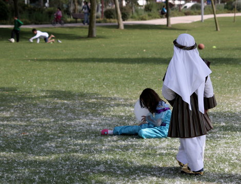 children playing in park during carnival or halloween, disguised as arabs