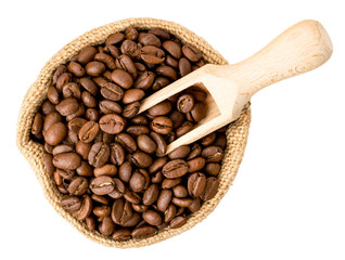 Obraz premium Coffee beans in a bag and a wooden spoon on a white. The form of the top.