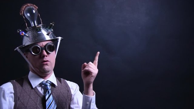 Nerd with aluminum hat pointing with finger to empty placeholder for animations