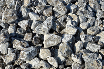 Natural gypsum stone. Close up image of stones with black and white. Industrial mining area. Limestone mining, quarry. Wall texture, stone background, round stones