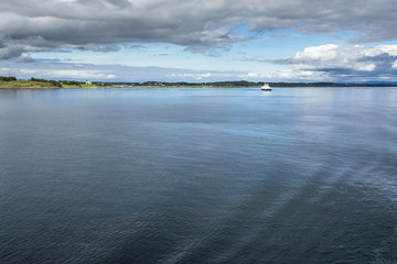 A ferry boat in the scenery landscape of Western Norway coastline