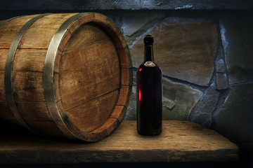 Red wine bottle on a old oak wooden table background barrel.