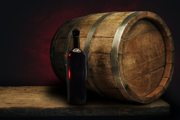 Red wine bottle on a old oak wooden table background barrel.