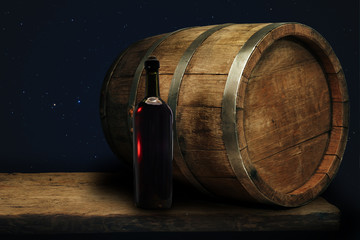 Red wine bottle on a old oak wooden table background barrel.