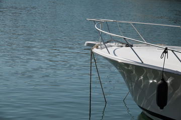 White bow of a real moored boat.