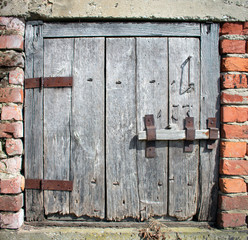 Vintage wooden doors with brick frame.