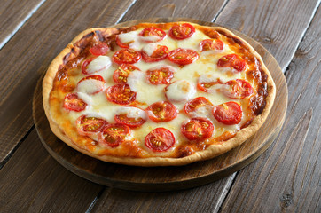 Pizza Margarita on wooden cutting board