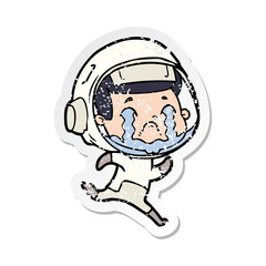 distressed sticker of a cartoon crying astronaut
