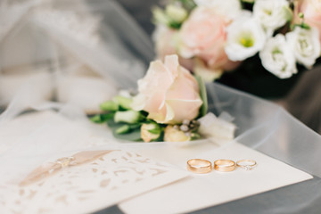 wedding rings on the background of the bouquet