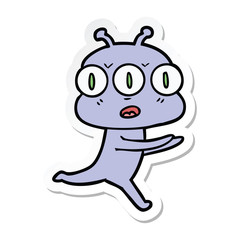 sticker of a cartoon three eyed alien