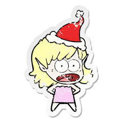 distressed sticker cartoon of a shocked elf girl wearing santa hat