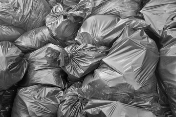 Fototapeta na wymiar Big pile of garbage and waste in black bags. Background.
