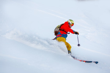 Naklejka na ściany i meble Man skier high speed rides on fresh snow, dust in air. Concept extreme winter sport