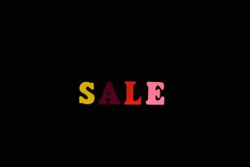 the inscription sale in colored letters on a black background