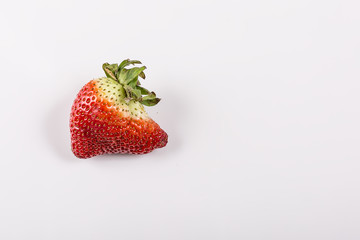 Ugly organic strawberries isolated on white background