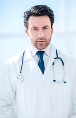 portrait of serious doctor on blurred background