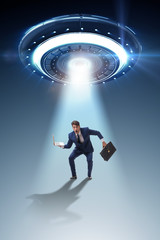 Flying saucer abducting young businessman 