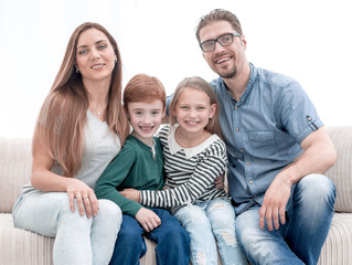 happy family sitting on the couch in the living room.