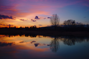 Beautiful red and blue colors and reflection after sunset over a lake