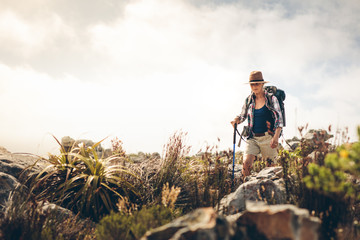 Woman trekking down a hill