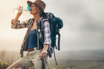 Portrait of a female hiker drinking water