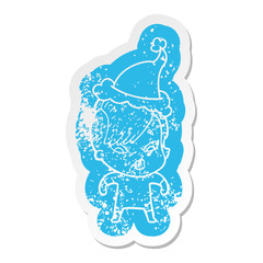 cartoon distressed sticker of a surprised girl wearing santa hat