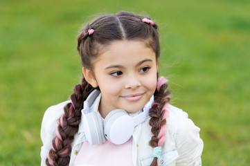 happy little girl. little girl listen music. Kid in headset. Stylish child relax on green grass. Spring mood. Mp3 player. time to relax. girl with mp3. listen mp3. Finding a peaceful place to relax