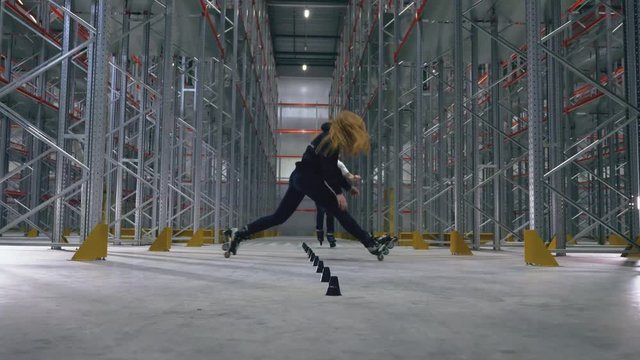 Roller skating stunts in the logistics center. Slalom tricks