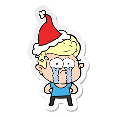 sticker cartoon of a crying man wearing santa hat