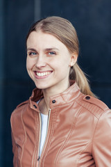 Beautiful young blonde smiling woman wearing casual outdoor